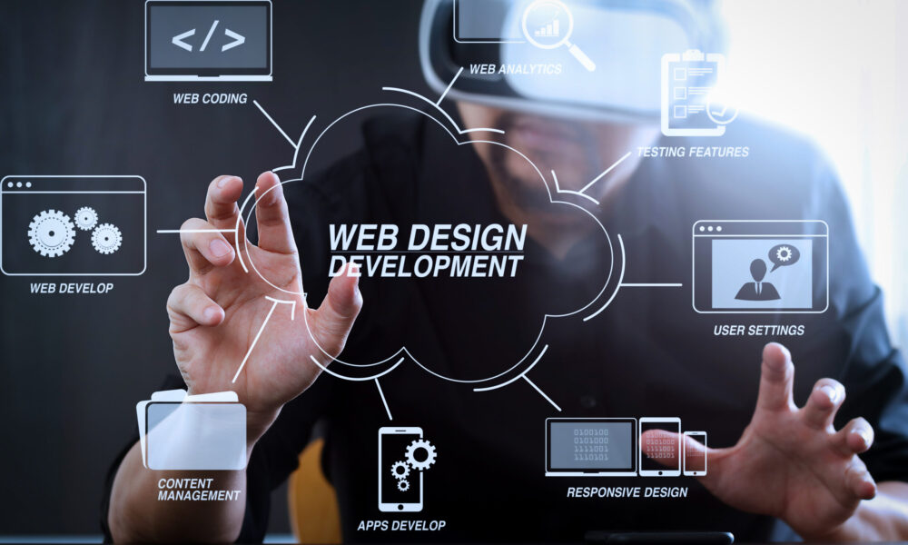 Developing programming and coding technologies with Website design in virtual diagram.businessman wearing virtual reality goggles in modern office with mobile phone using with VR headset